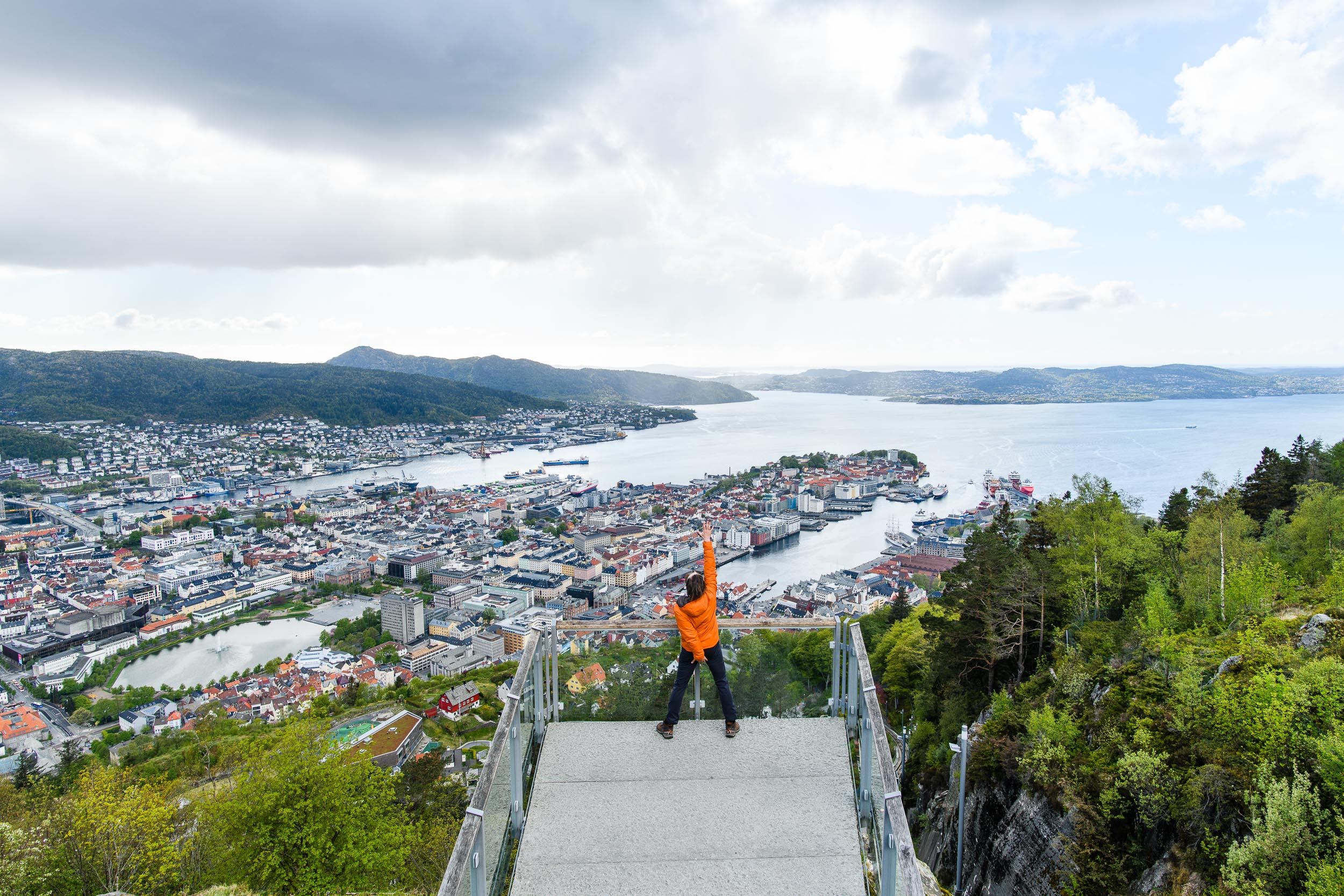 View from Mount Fløyen, overlooking Bergen, Norway. A victorious pose after skipping the floibanen to hike up the hill.
