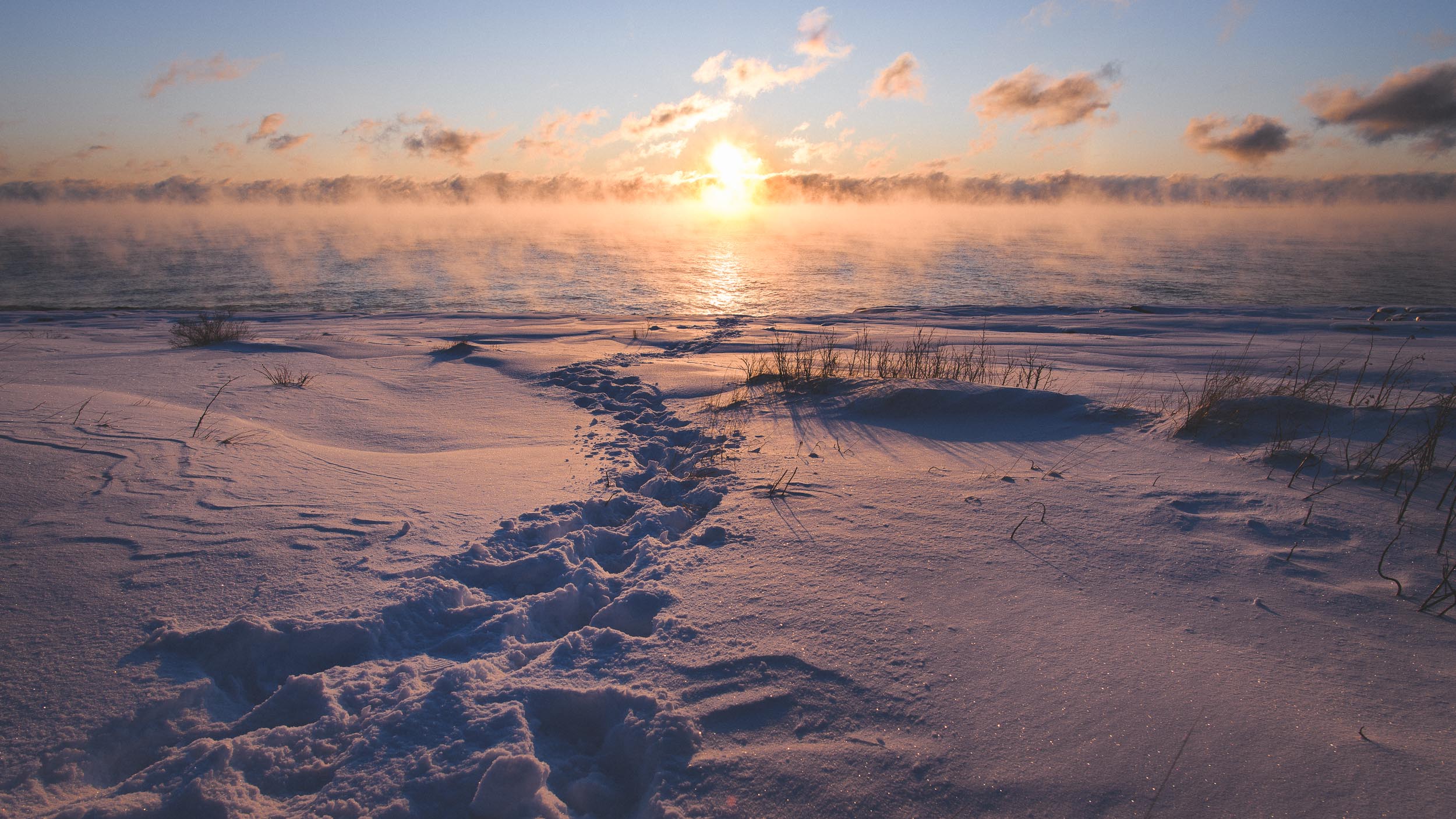 Footsteps lead to water's edge on Lake Superior for a sunrise at Gooseberry Falls State Park on Lake Superior in Minnesota.
